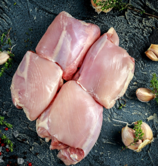 Four raw, boneless Chicken Thighs presented on a dark, rustic surface with cloves of garlic and sprigs of thyme.