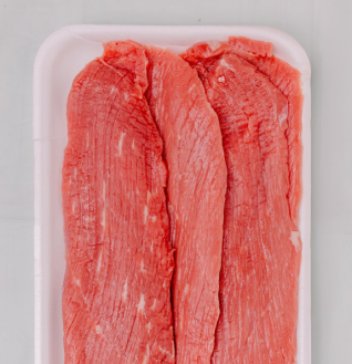 Raw Beef Pasanda slices arranged on a white styrofoam tray