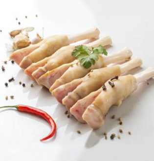 "Row of raw Goat and Lamb Paya (trotters/feet) bones, garnished with peppercorns, ginger, and a red chili pepper.