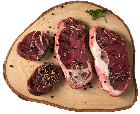 Organic, Zabiha halal, and USDA approved beef steaks on a wooden board.